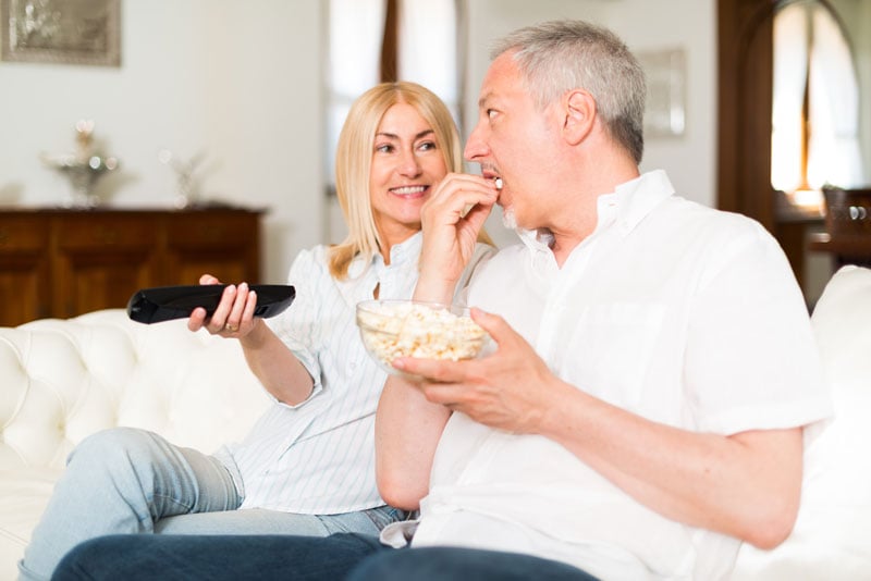 Couple watching TV and talking